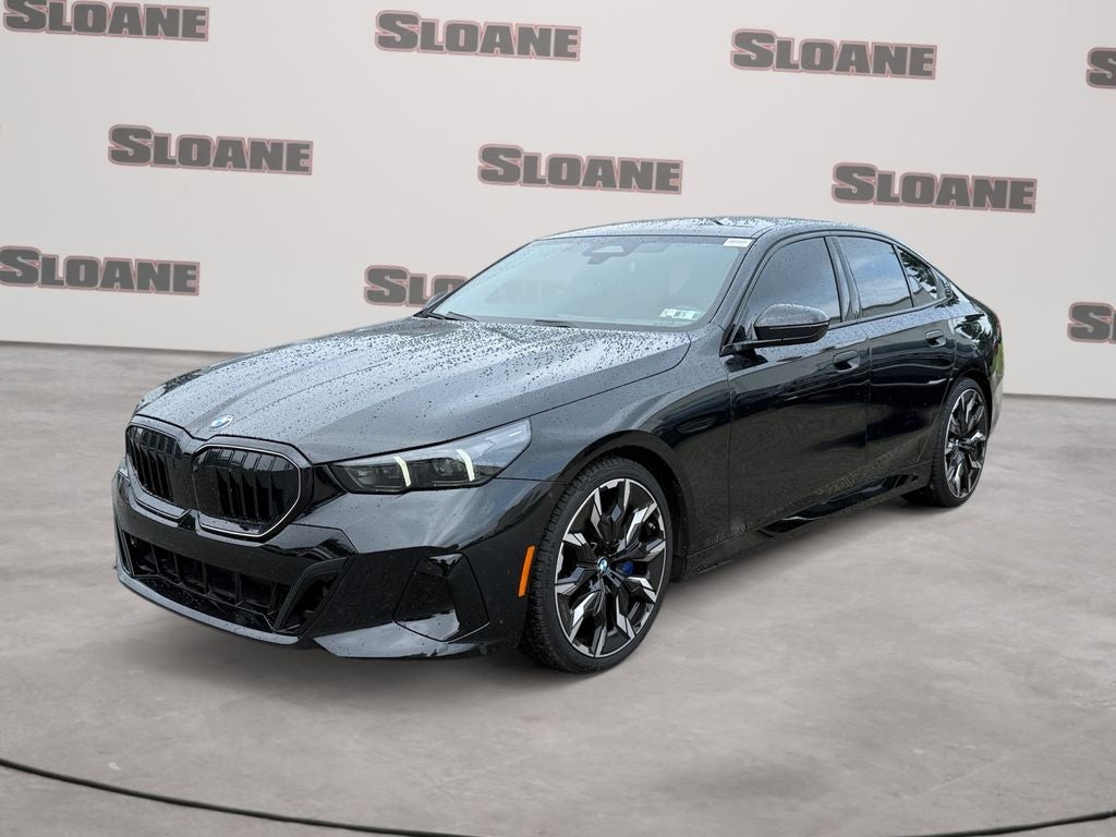 2026 BMW 5 Series 540i xDrive M Sport in Black Sapphire Metallic — front three-quarter view